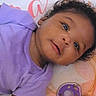 baby, baby_clothes, child, close_up, curly_hair, cute, eyes, face, happy, head, indoors, infant, lying_down, mouth, pacifier, portrait, purple_shirt, skin, smile, soft_surface