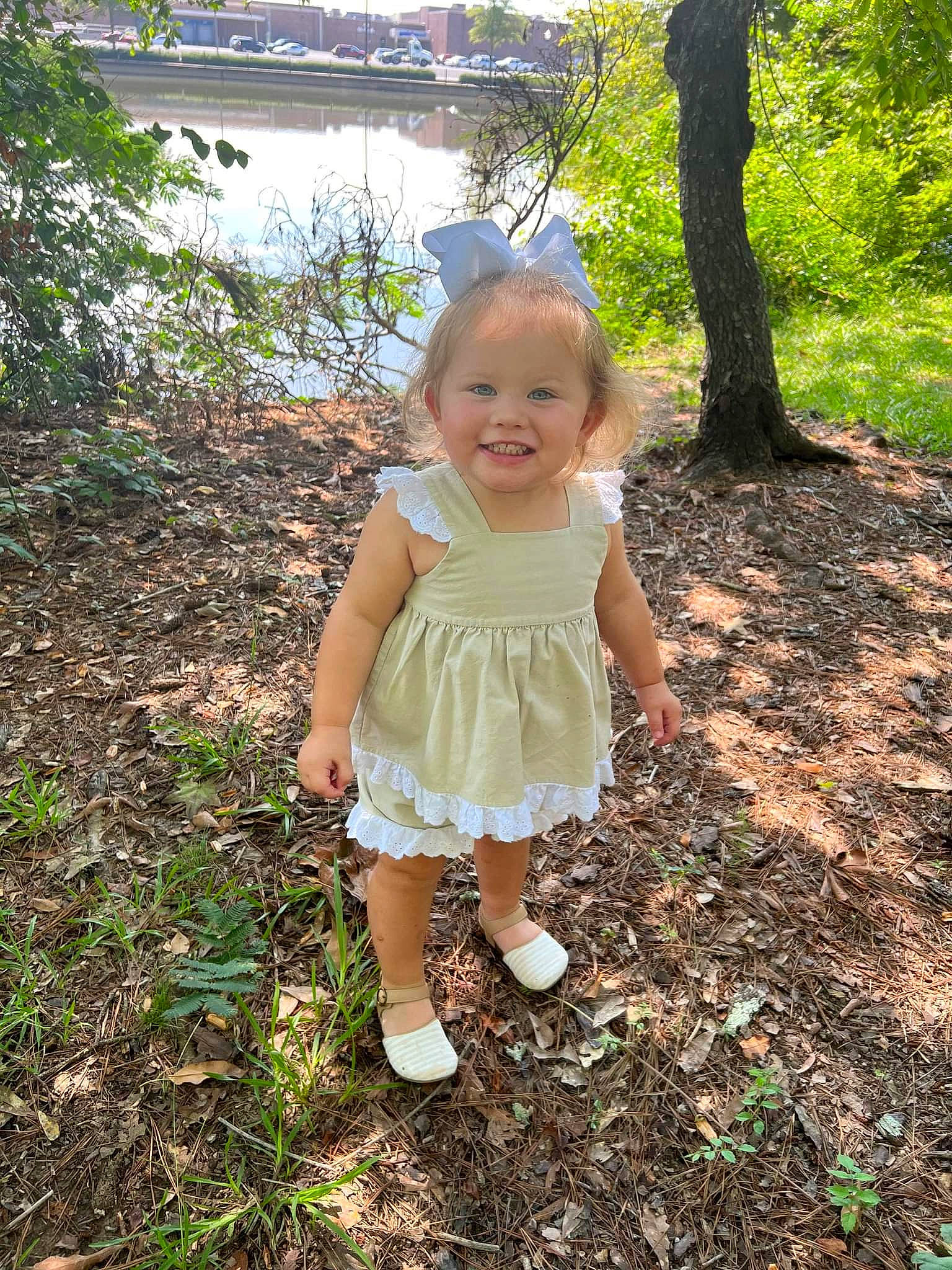 Paisley-grace is registered to the contest to win money with this photo: baby_toddler_clothing, child, forest, fun, grass, happy, joy, lake, pattern, people_in_nature, person, plant, recreation, sandal, shorts, smile, soil, summer, toddler, tree