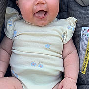 Stevie is registered to the contest to win money with this photo: baby, infant, onesie, car_seat, smiling, tongue_out, cute, chubby_cheeks, comfortable, child, seated, clothing, indoor, portrait, happy, person, skin, face, young, expression