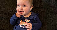 Stevie joined the competition — help win amazing prizes! toddler, child, baby, sitting, couch, indoor, clothing, pants, long_sleeve_shirt, hair_clips, blue_clothing, cute, smiling, face, person, young_child, portrait, home, casual, seated