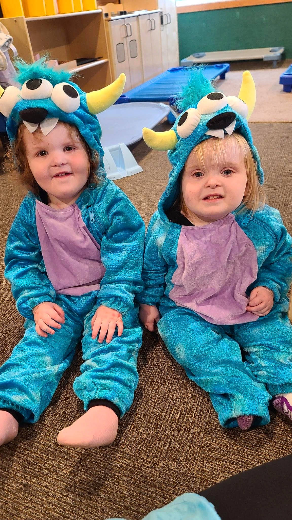 Catherine is registered to the contest to win money with this photo: azure, baby, baby_toddler_clothing, blue, event, fun, goggles, grass, happy, headwear, joy, leisure, person, pink, plant, purple, recreation, sitting, skin, smile