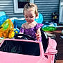 Aurora joined the competition — help win amazing prizes! toddler, child, toy_car, pink, outdoor, playtime, pool_toys, inflatable, summer, sunlight, hair_tie, purple_dress, deck, window, house_siding, steering_wheel, cute, young, fun, concentration