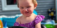 Aurora joined the competition — help win amazing prizes! toddler, child, toy_car, purple_dress, smiling, outdoor, playtime, hair_ponytail, baby, sunlight, window, plastic_toy, happy, young_child, summer, backyard, person, steering_wheel, cute, fun