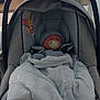 baby, car_seat, blanket, pacifier, indoor, infant, sleeping, headwear, soft_toys, child, fabric, cushion, person, newborn, resting, baby_clothes, seat, comfort, nap, home