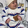 baby, infant, child, smiling, hat, knitwear, striped_clothing, shoes, white_shoes, blanket, animal_print, cute, cozy, sitting, portrait, happy, indoor, soft_texture, warm_clothing, person