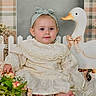 Myah is registered to the contest to win money with this photo: baby, child, infant, flower_bouquet, lace_dress, headband, duck_toy, decorative_duck, pink_bow, fluffy_rug, soft_toys, pastel_colors, indoor, portrait, cute, smiling, sitting, baby_feet, white_fabric, vintage_style