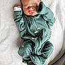 Raphael is registered to the contest to win money with this photo: baby, newborn, sleeping, onesie, green_clothing, blanket, infant, peaceful, cute, soft_texture, child, portrait, indoors, resting, small, human, toddler, peace, cozy, sleep