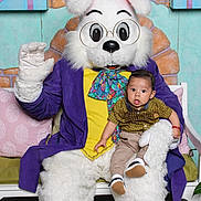 Jesús Emilio Vargas joined the competition — help win amazing prizes! baby, child, person, costume, bunny, rabbit, glasses, purple_jacket, yellow_shirt, colorful_scarf, flowers, bench, indoor, holiday, spring, celebration, cute, smiling, decor, pose