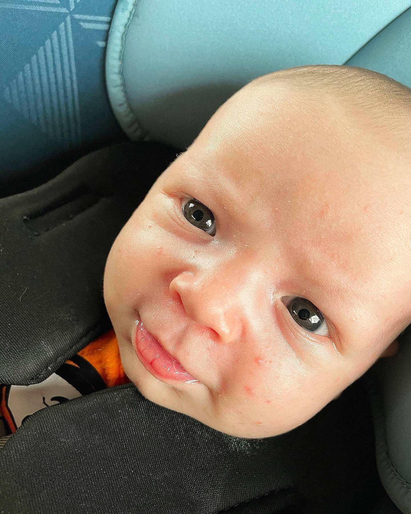 Chris is registered to the contest to win money with this photo: baby, baby_toddler_clothing, car_seat, cheek, child, ear, eyebrow, eyelash, gesture, happy, jaw, lip, mouth, nail, nose, person, skin, smile, thumb, toddler