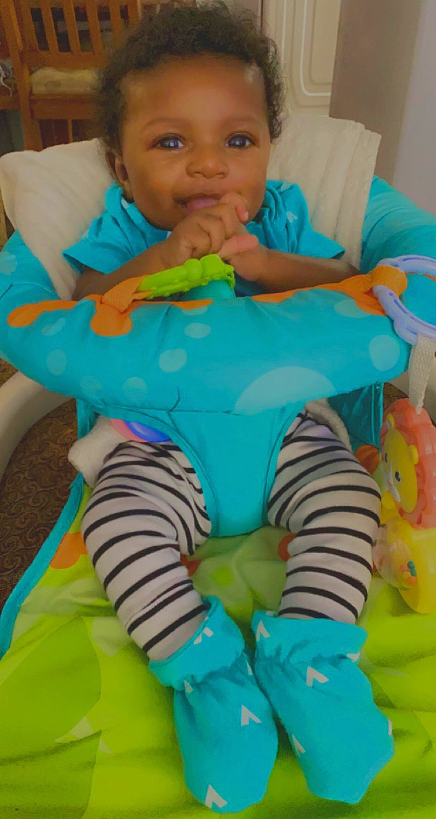 Antwan is registered to the contest to win money with this photo: aqua, azure, baby, baby_products, baby_safety, baby_toddler_clothing, blue, chair, cheek, child, comfort, electric_blue, fun, green, head, linens, organ, person, sitting, textile