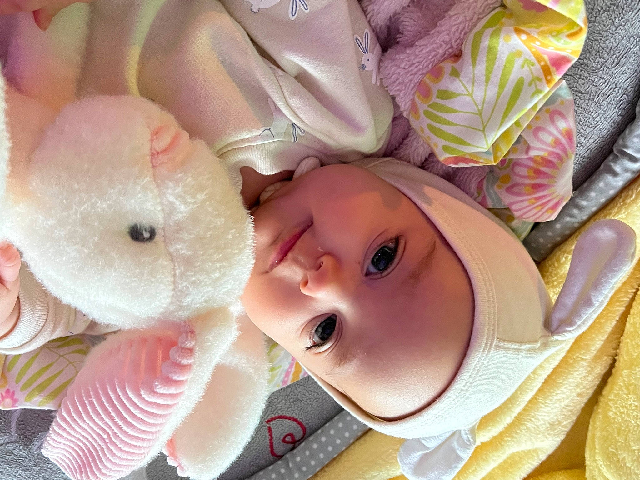 Celeste is registered to the contest to win money with this photo: baby, baby_products, cheek, child, eye, eyelash, face, hat, head, headgear, lip, nose, person, pink, skin, smile, stuffed_toy, sun_hat, textile, toddler