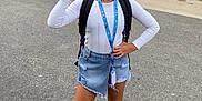 Theanna a rejoint le concours — aidez-le/la à gagner de superbes lots ! child, girl, smiling, peace_sign, white_long_sleeve, denim_skirt, sneakers, backpack, lanyard, id_card, road, outdoor, plants, fence, asymmetrical_skirt, standing, casual, happy, young_person, urban
