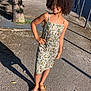 Theanna participe au concours pour gagner de l'argent avec cette photo : child, girl, curly_hair, floral_dress, sandals, outdoor, sunlight, shadow, sidewalk, tree, street, car, urban, smiling, happy, summer, fashion, pose, daytime, casual