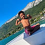 Ethan a rejoint le concours — aidez-le/la à gagner de superbes lots ! blue_sky, boat, boy, child, happy, lake, landscape, mountain, muscle_pose, nature, outdoor, scenic, shirtless, shorts, smile, summer, sunny, travel, vacation, water