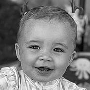Raya is registered to the contest to win money with this photo: baby, child, face, smile, happy, hair, ponytails, clothing, striped, ruffles, portrait, closeup, black_and_white, cute, infant, young, eyes, background_blur, octopus, indoor