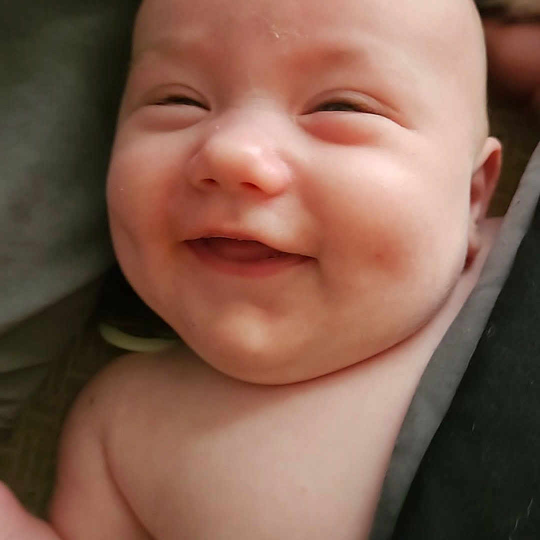 Olivia joined the competition — help win amazing prizes! baby, smiling, face, skin, expression, child, infant, blanket, happy, closeup, head, human, cute, portrait, newborn, soft, warm, cheerful, indoors, person