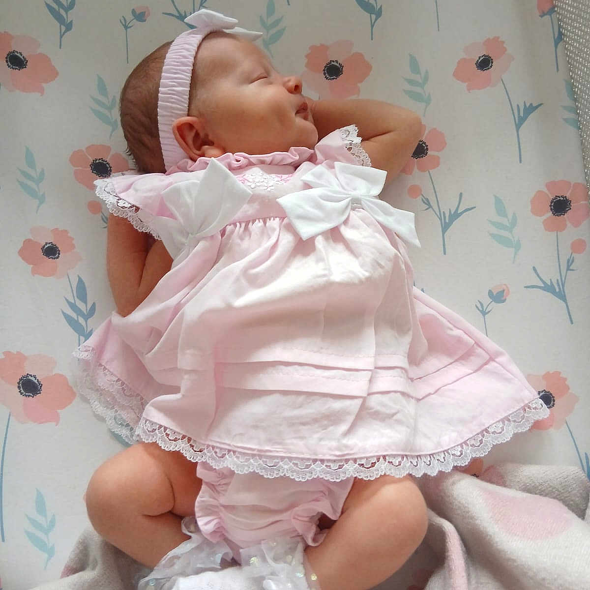 Florence is registered to the contest to win money with this photo: adorable, baby, blanket, bows, child, cute, dress, floral_pattern, headband, indoors, infant, newborn, peaceful, pink, portrait, resting, sleeping, small, socks, soft