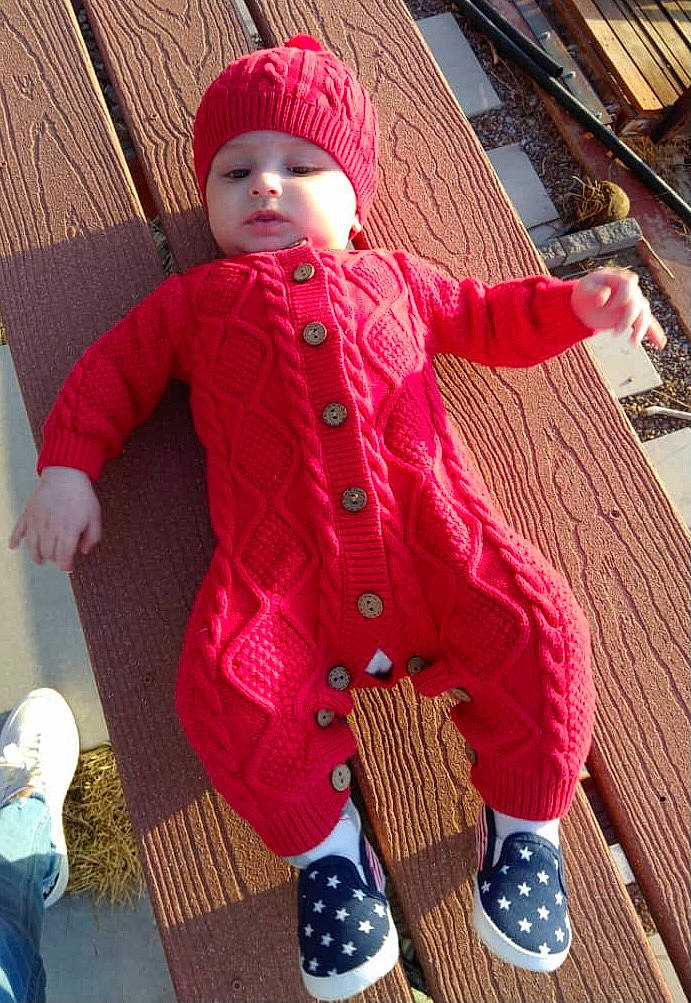 Charlie is registered to the contest to win money with this photo: baby, baby_toddler_clothing, blue, cap, child, cool, flooring, headgear, headwear, magenta, orange, pattern, person, pink, red, sitting, skin, sleeve, textile, toddler