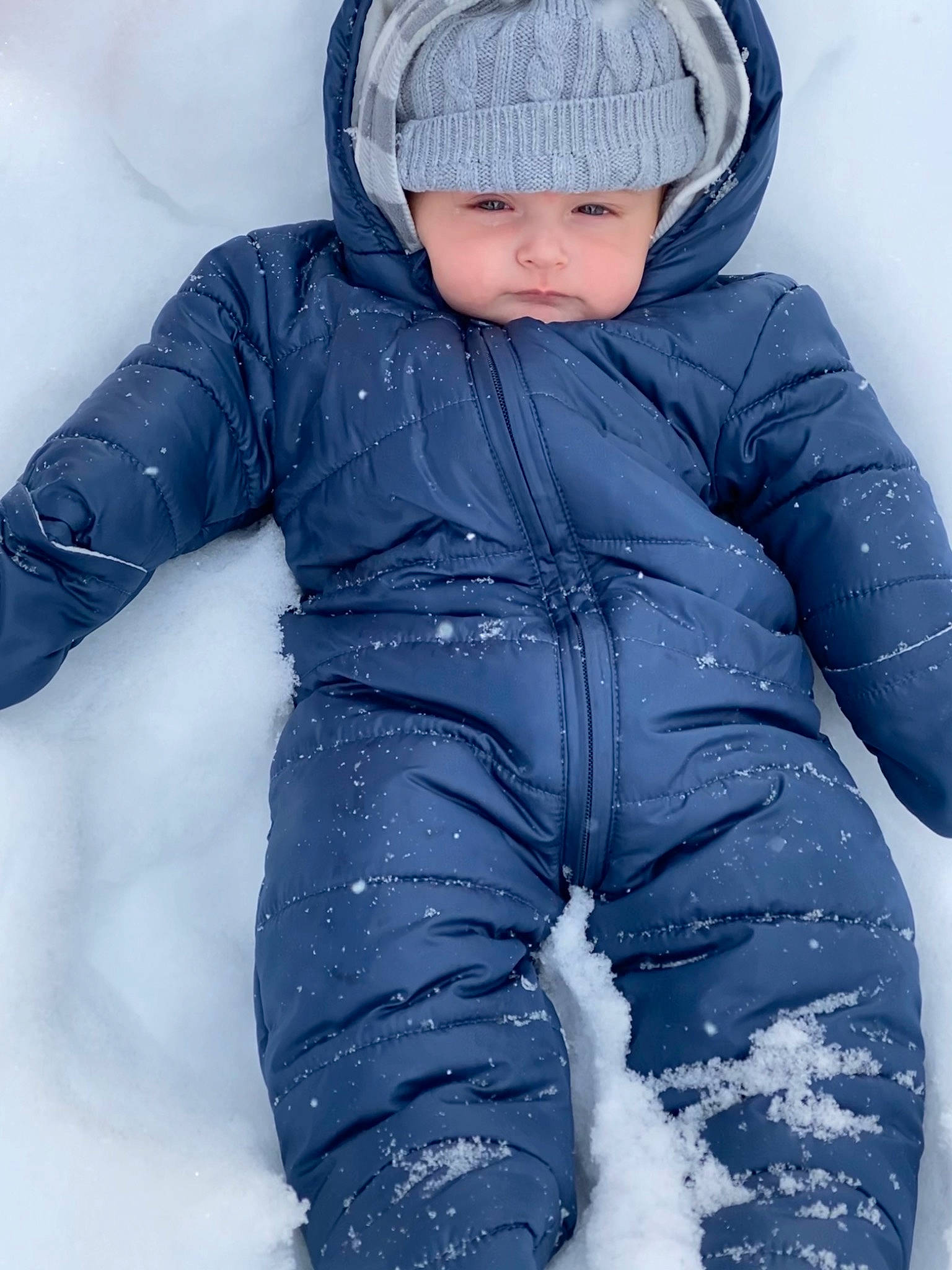 Charlie is registered to the contest to win money with this photo: baby, baby_toddler_clothing, beauty, cap, cheek, child, comfort, electric_blue, face, freezing, glove, head, headgear, headwear, jacket, outerwear, person, personal_protective_equipment, photograph, sleeve