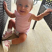 Hailey Grace is registered to the contest to win money with this photo: toddler, child, smiling, sitting, pink_shoes, pink_top, pony_tail, wicker_chair, outdoor, concrete_floor, happy, young_child, cute, blue_eyes, casual_clothing, playful, sunlight, furniture, baby, person