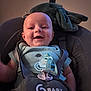 baby, baby_accessory, baby_seat, child, closeup, clothing, comfort, cute, dinosaur_print, face, happy, head, indoor, infant, onesie, pacifier, person, seat, smiling, straps