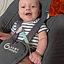 baby, baby_seat, blanket, blue_eyes, child, clip, closeup, comfort, face, hand, happy, indoor, infant, pacifier, person, safety_strap, seat, skin, smiling, striped_clothing