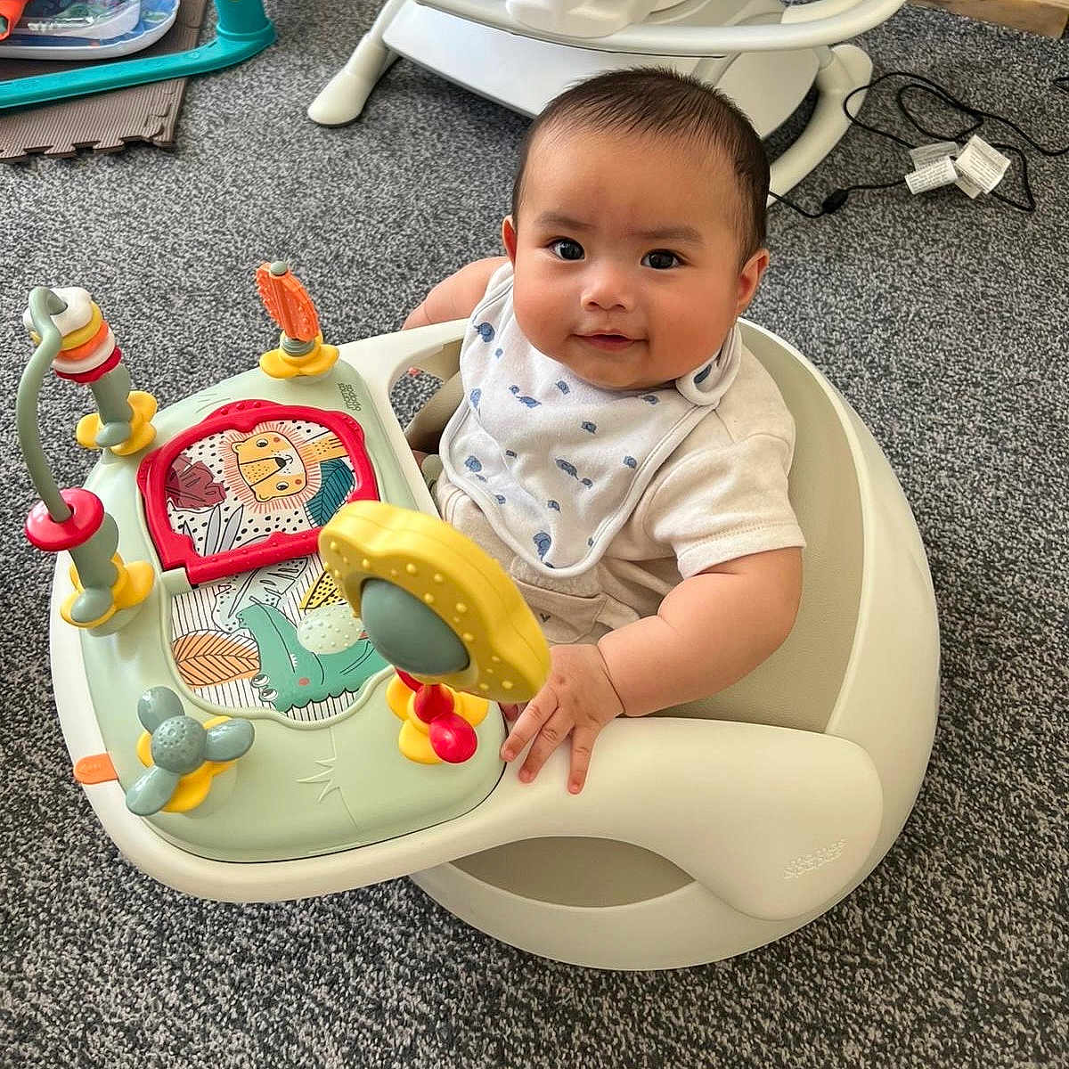 Theo is registered to the contest to win money with this photo: baby, basin, bathroom, chair, clothing, face, furniture, happy, head, indoors, person, photography, playarea, portrait, room, sitting, sleeve, smile, t_shirt, toilet