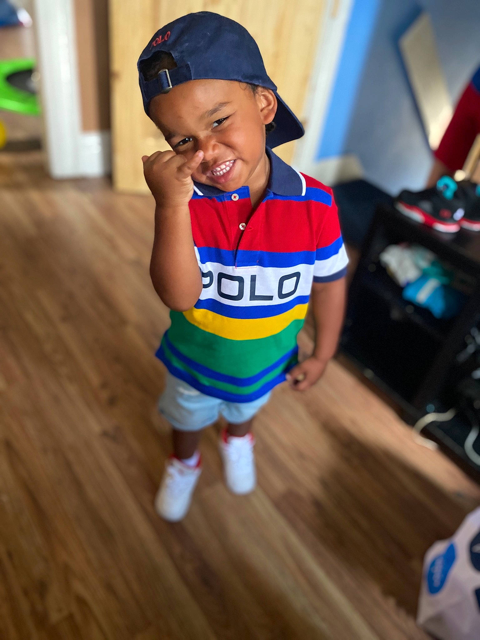 Karter is registered to the contest to win money with this photo: baby, blue, cap, child, floor, flooring, footwear, headgear, headwear, joy, person, play, shoe, skin, sports_uniform, sportswear, t_shirt, toddler, vacation, yellow