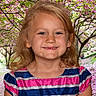 blonde_hair, cherry_blossoms, child, cute, face, flowers, girl, greenery, happy, nature, outdoor, park, person, portrait, smile, spring, striped_dress, sunlight, tree, young