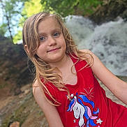 Airabella joined the competition — help win amazing prizes! child, girl, blonde_hair, red_tank_top, unicorn_graphic, outdoor, waterfall, nature, greenery, smiling, portrait, summer, casual_clothing, happy, young, scenic, background_blur, daylight, cute, posing