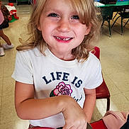 Airabella joined the competition — help win amazing prizes! blonde_hair, casual_clothing, chair, child, classroom, daylight, desk, education, flower_graphic, happy, indoor, kid, missing_tooth, person, playful, school_supplies, smiling, table, tshirt, young_child