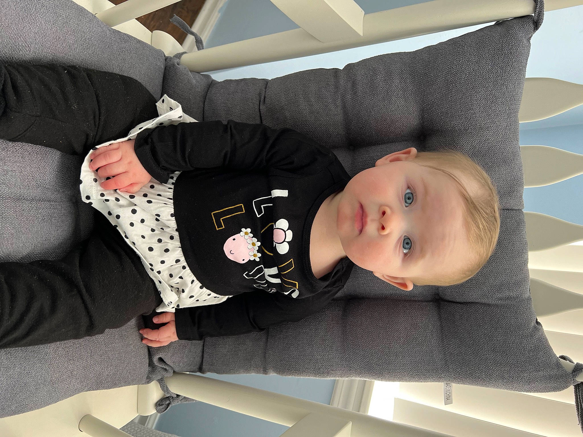 Greenlee is registered to the contest to win money with this photo: baby, baby_carriage, baby_products, baby_safety, baby_toddler_clothing, child, comfort, flooring, linens, pattern, person, room, sitting, sleeve, toddler, white, wood