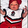 Grace is registered to the contest to win money with this photo: baby, infant, child, red_bow, white_outfit, red_pants, blanket, dotted_blanket, cute, portrait, indoors, lying_down, small_hands, face, headwear, person, newborn, expression, looking_at_camera, adorable