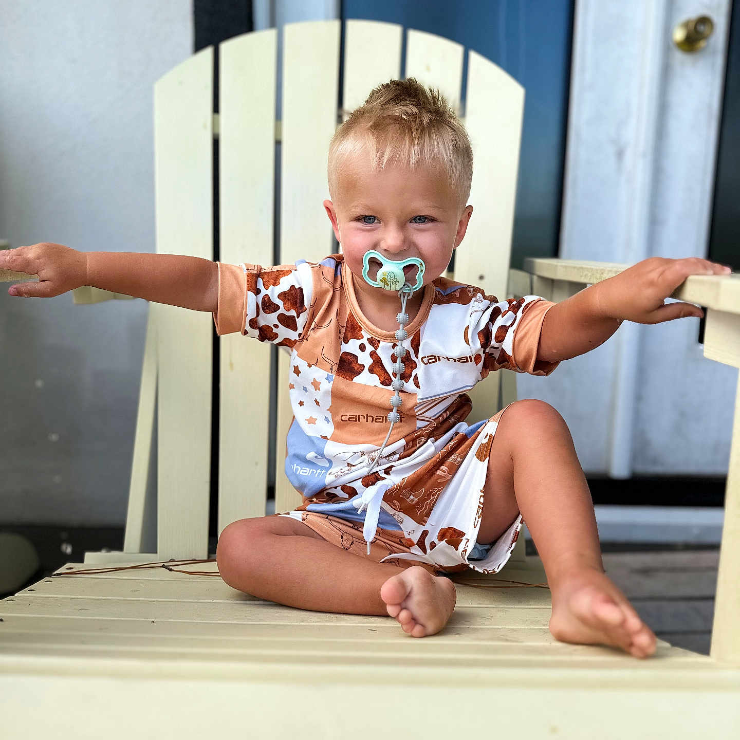 Stetson is registered to the contest to win money with this photo: accessories, baby, bodypart, chair, clothing, face, finger, furniture, glasses, hand, head, person, photography, plywood, portrait, shorts, sitting, sunglasses, t_shirt, wood