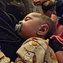 baby, blanket, child, clothing, comfort, couch, cozy, face, family, head, indoor, milk_carton_print, onesie, pacifier, person, portrait, resting, sleeping, soft_lighting, young_child