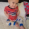 Zachary joined the competition — help win amazing prizes! toddler, child, baby, smile, red_shirt, striped_shirt, pajamas, cookie_monster, bedspread, quilted, indoor, sitting, foot, hand, cute, face, person, clothing, expression, playful
