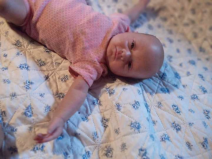 Hazzel is registered to the contest to win money with this photo: baby, baby_products, baby_toddler_clothing, bed, bedding, bedtime, blanket, child, comfort, flooring, linens, pattern, person, room, skin, textile, toddler, wood