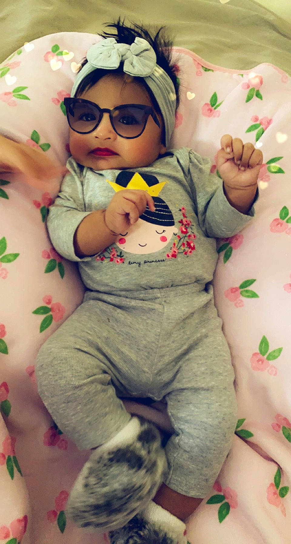 Madelynn is registered to the contest to win money with this photo: arm, baby, baby_toddler_clothing, cheek, eye, face, facial_expression, glasses, goggles, green, hand, happy, head, mouth, person, pink, product, skin, sleeve, textile