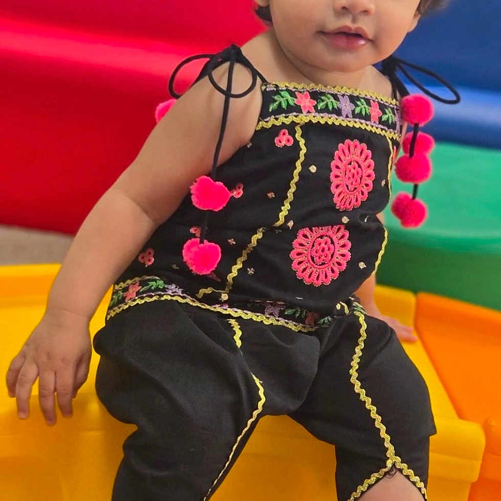 Aleezay joined the competition — help win amazing prizes! toddler, child, playground, colorful, pom_poms, black_clothing, sitting, indoor, play_area, curly_hair, headband, barefoot, carpet, bright_colors, cute, portrait, young_child, smiling, window, daylight