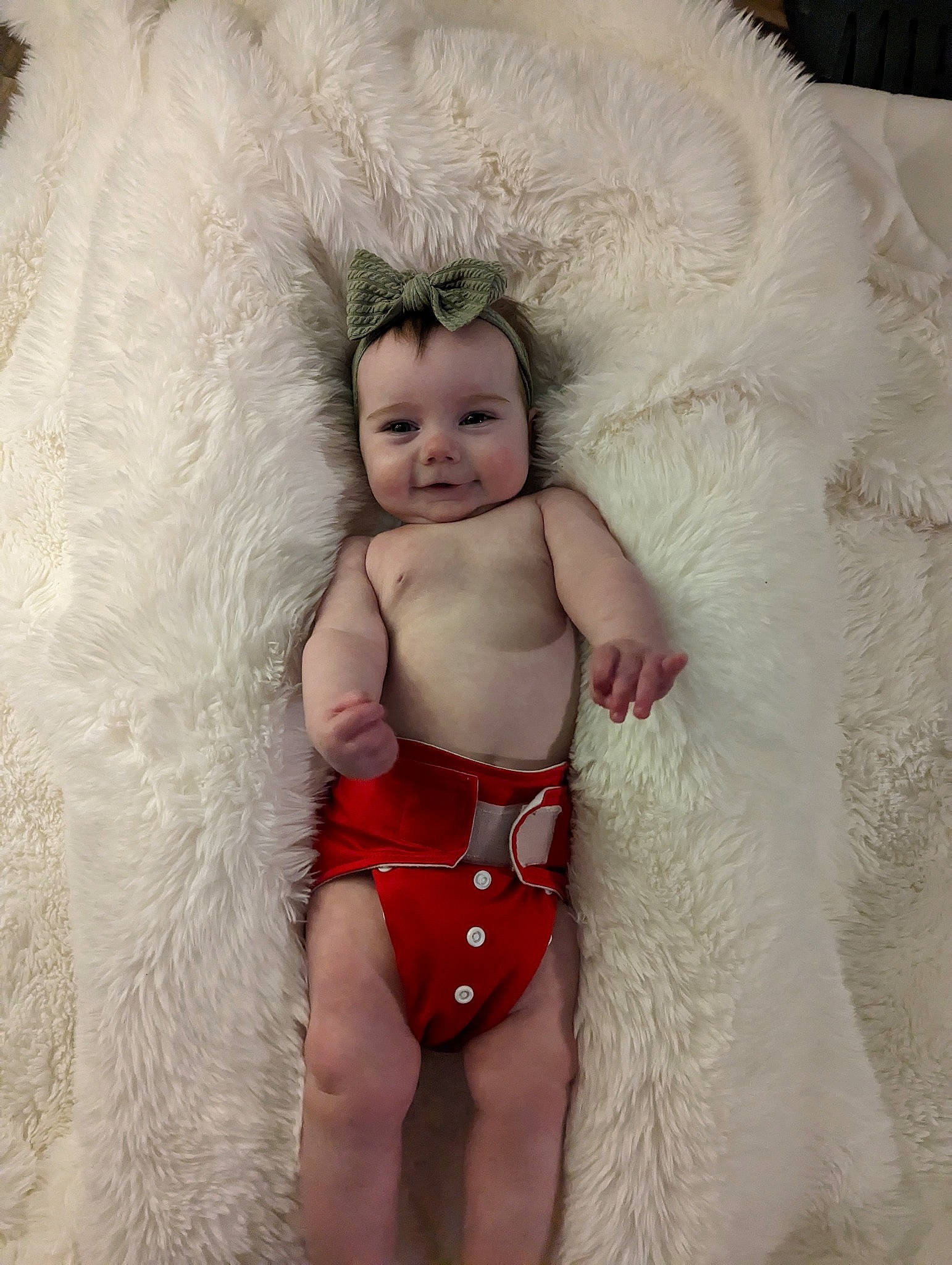 Magnolia is registered to the contest to win money with this photo: abdomen, baby, baby_toddler_clothing, chest, child, costume, eye, fashion_accessory, head, human_body, human_leg, joy, lip, navel, person, sitting, stomach, swimwear, thigh, toddler