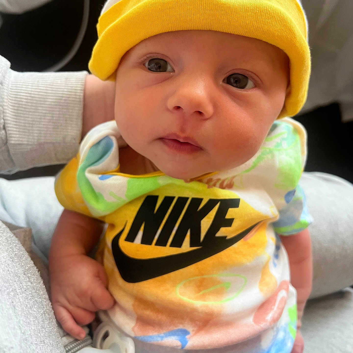 Halo joined the competition — help win amazing prizes! baby, infant, child, nike, hat, yellow, colorful_clothes, pacifier, close_up, portrait, cute, soft_lighting, hand, fabric, apparel, newborn, person, looking, indoors, casual