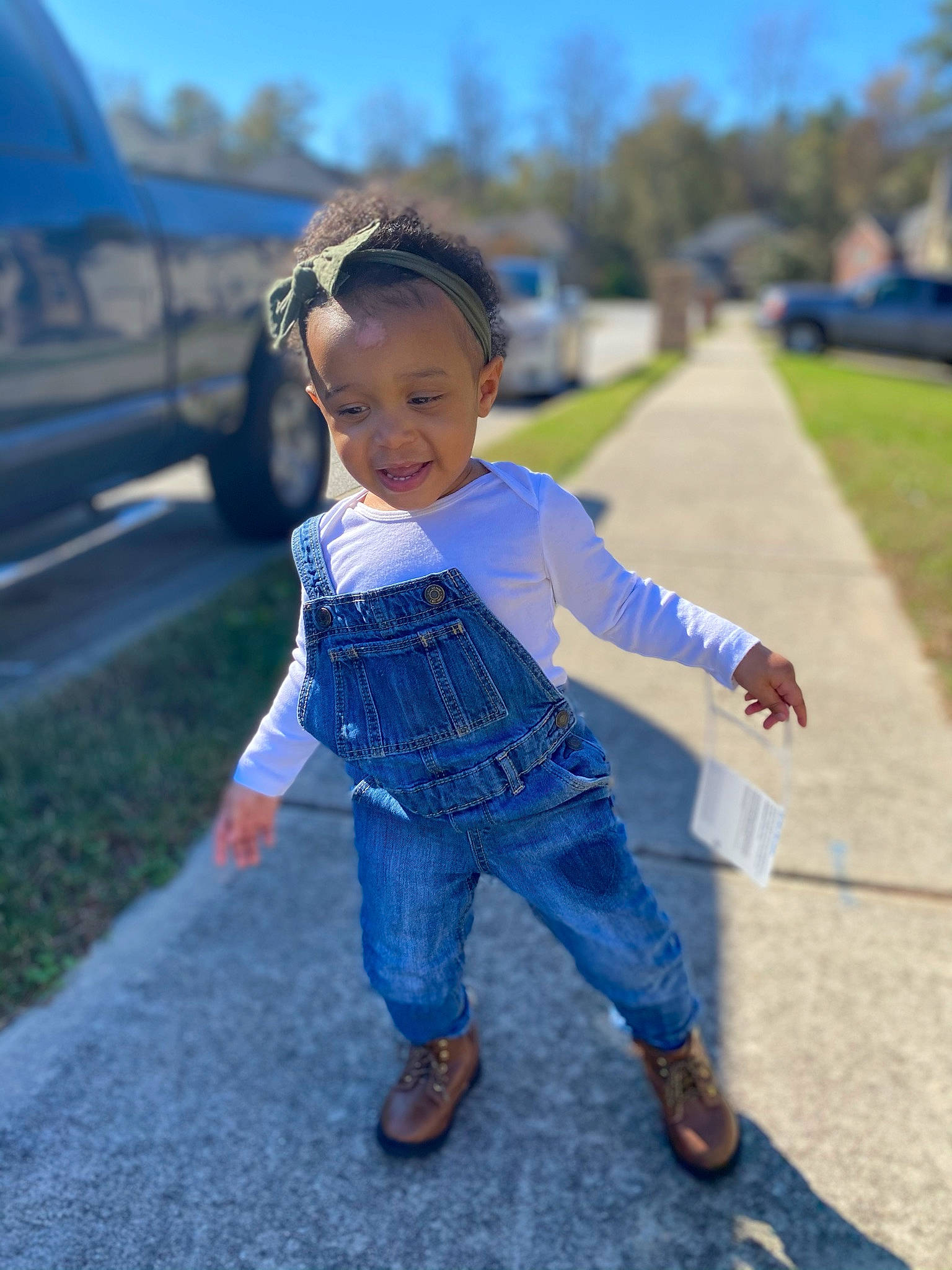 Leyana is registered to the contest to win money with this photo: child, cool, denim, electric_blue, fun, grass, grassland, hairstyle, happy, leisure, person, plant, public_space, sky, smile, standing, street_fashion, summer, toddler, tree