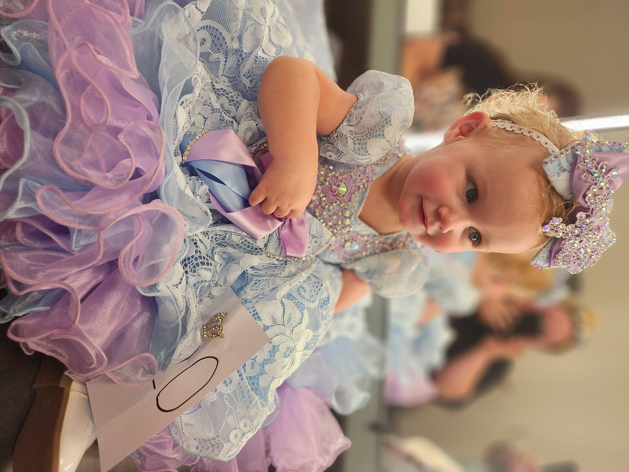 Nevaeh is registered to the contest to win money with this photo: baby, bridal_accessory, bridal_clothing, dress, embellishment, event, eye, eyelash, fashion_design, hair_accessory, happy, headgear, headpiece, iris, jewellery, person, pink, plant, toddler, toy