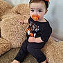 toddler, child, pacifier, headband, halloween, black_clothing, teddy_bear, plush_toy, carpet, indoor, cute, baby, sitting, barefoot, expression, wall, decorative, orange, black, holiday