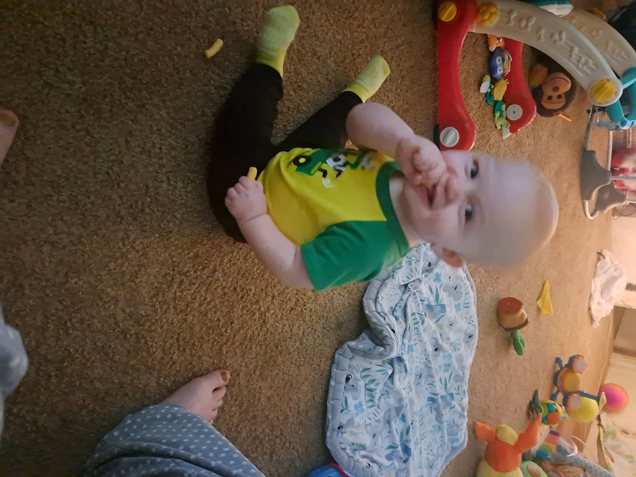 Liam is registered to the contest to win money with this photo: baby, baby_products, baby_toddler_clothing, baby_toys, child, flooring, foot, fun, happy, person, plastic, play, room, sitting, stuffed_toy, toddler, toy, wood