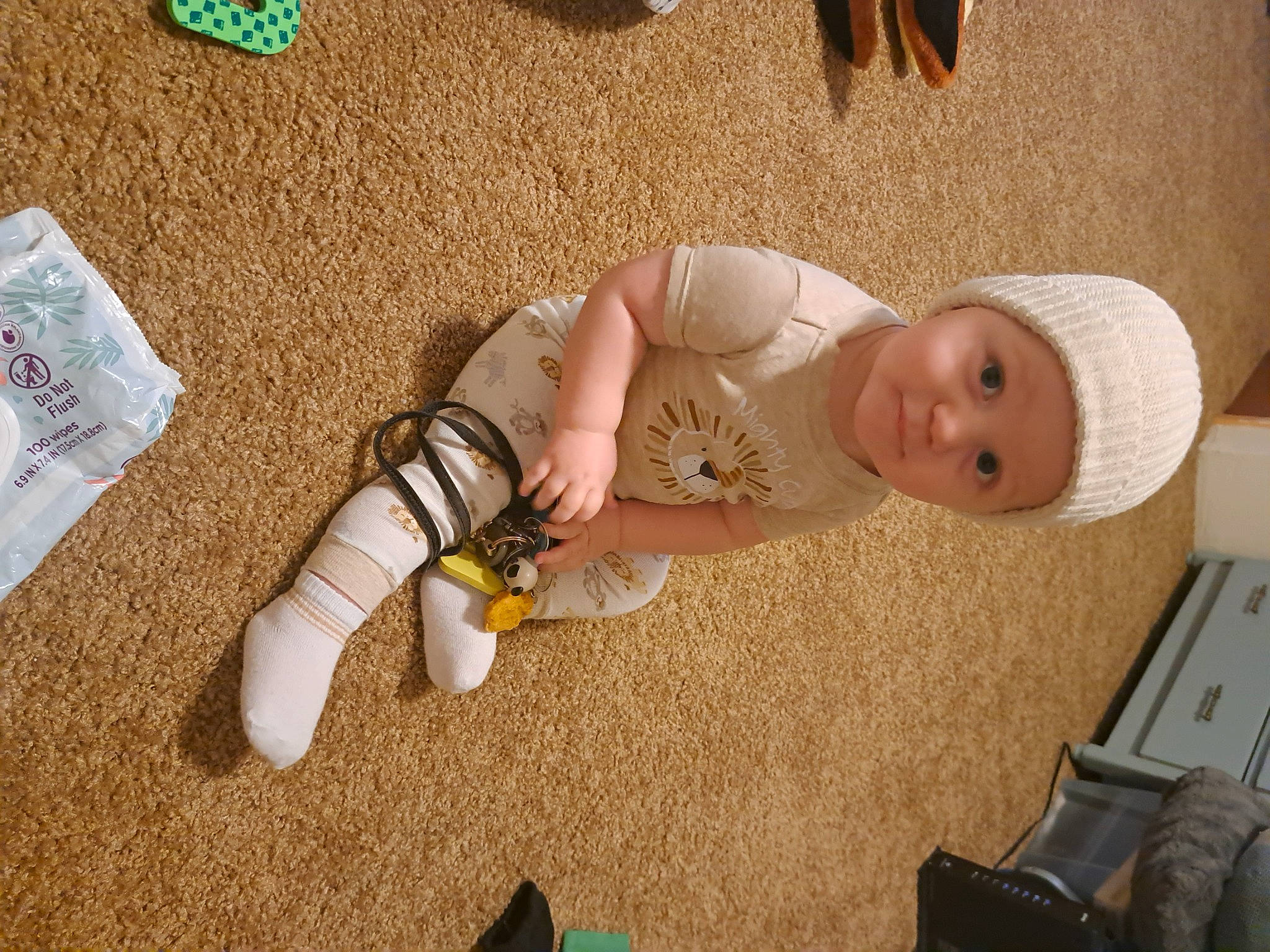 Liam joined the competition — help win amazing prizes! baby, child, comfort, fawn, finger, flooring, foot, fun, hat, headwear, human_leg, joint, knee, nail, person, sitting, skin, thigh, toddler, toy