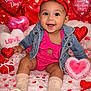 baby, infant, smiling, valentine, heart_balloon, plush_heart, denim_jacket, red_headband, sparkly_bow, pink_outfit, sitting, studio_background, heart_confetti, cute, portrait, boots, socks, holiday_shoot, happy, props