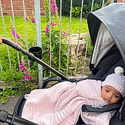 Ayra is registered to the contest to win money with this photo: baby, backyard, clothing, face, flower, geranium, grass, hat, head, jar, nature, person, photography, plant, planter, portrait, pottedplant, pottery, tree, vase