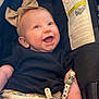 Kimberly joined the competition — help win amazing prizes! baby, smile, headband, car_seat, pacifier_clip, black_shirt, patterned_shorts, child, infant, happy, cute, indoor, person, young_child, clothing, accessory, seat, sitting, closeup, face