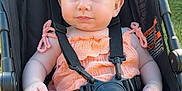 Kimberly joined the competition — help win amazing prizes! baby, child, stroller, outdoor, sunlight, headband, blue_eyes, peach_clothing, sitting, safety_harness, infant, cute, summer, portrait, young_child, legs, hands, face, expression, relaxation